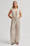 Woman wearing a beige sleeveless top and wide-leg pants on a white background from Second Female