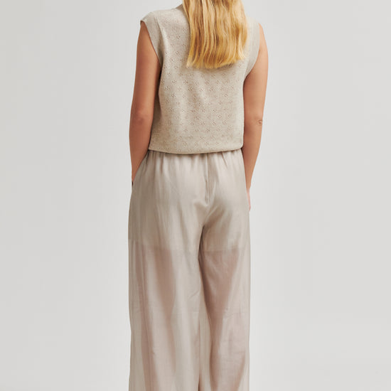 Rear view of Woman wearing a beige sleeveless top and wide-leg pants on a white background from Second Female