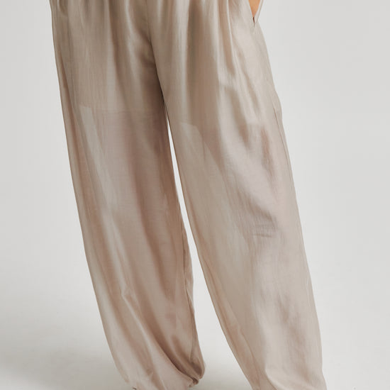 Beige wide-leg pants worn by a person on a white background from Second Female
