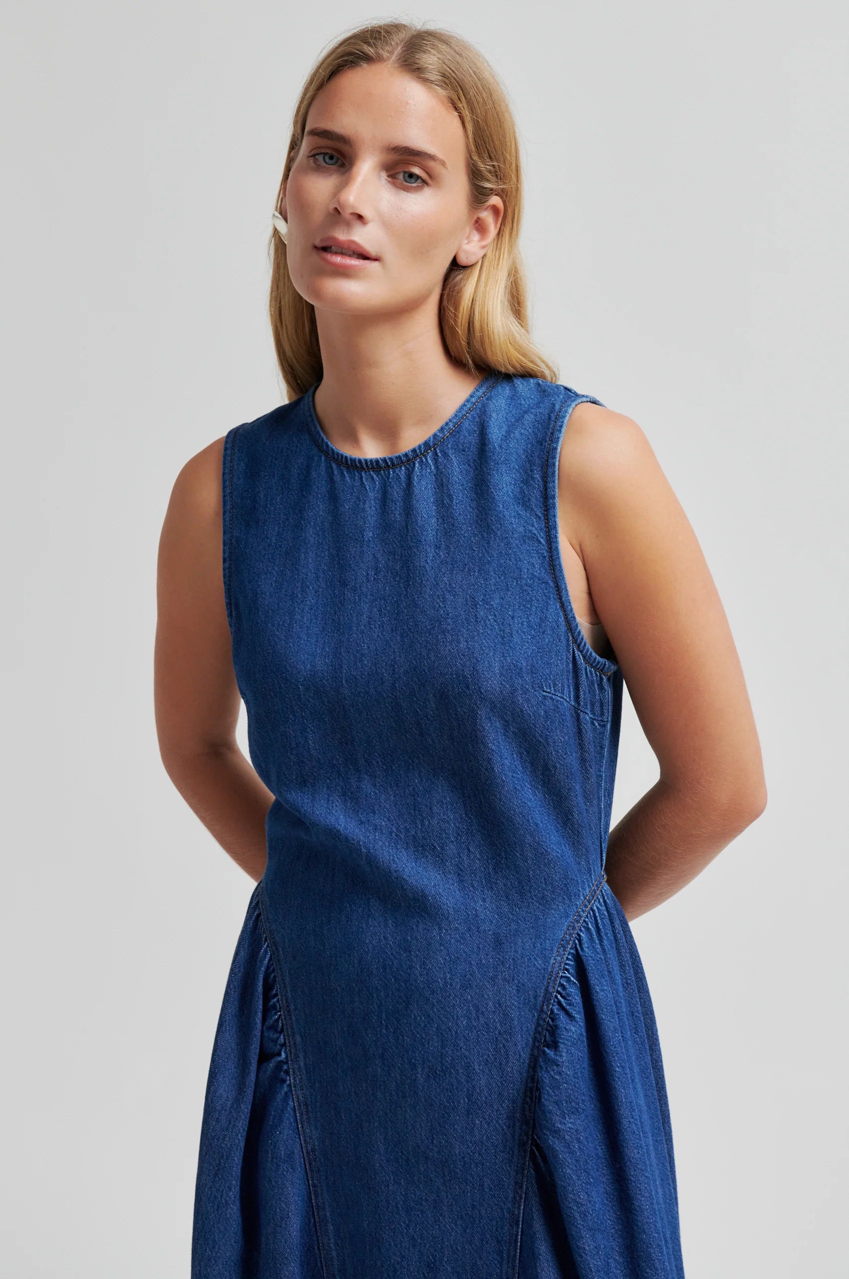 Blue denim dress by second female on a woman close up