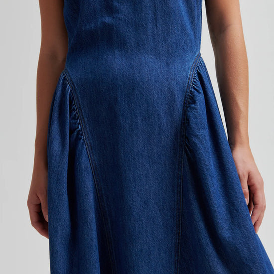 Blue denim dress by second female on a woman close up of hip detail