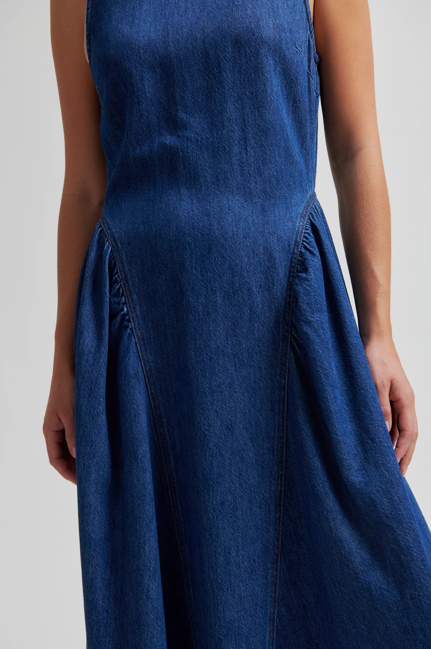 Blue denim dress by second female on a woman close up of hip detail