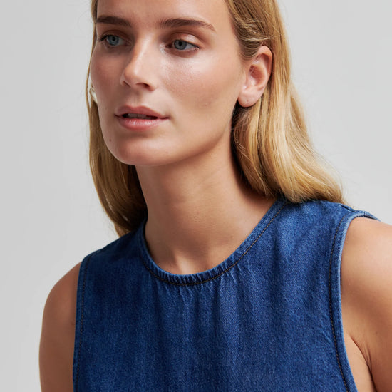 Blue denim dress by second female on a woman close up of neckline