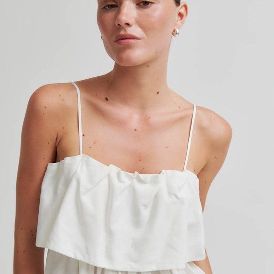 Woman wearing a white dress against a plain background from Second Female