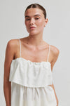 Woman wearing a white dress against a plain background from Second Female