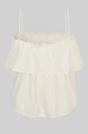 Cream-colored top with ruffled layers on a light gray background rear view