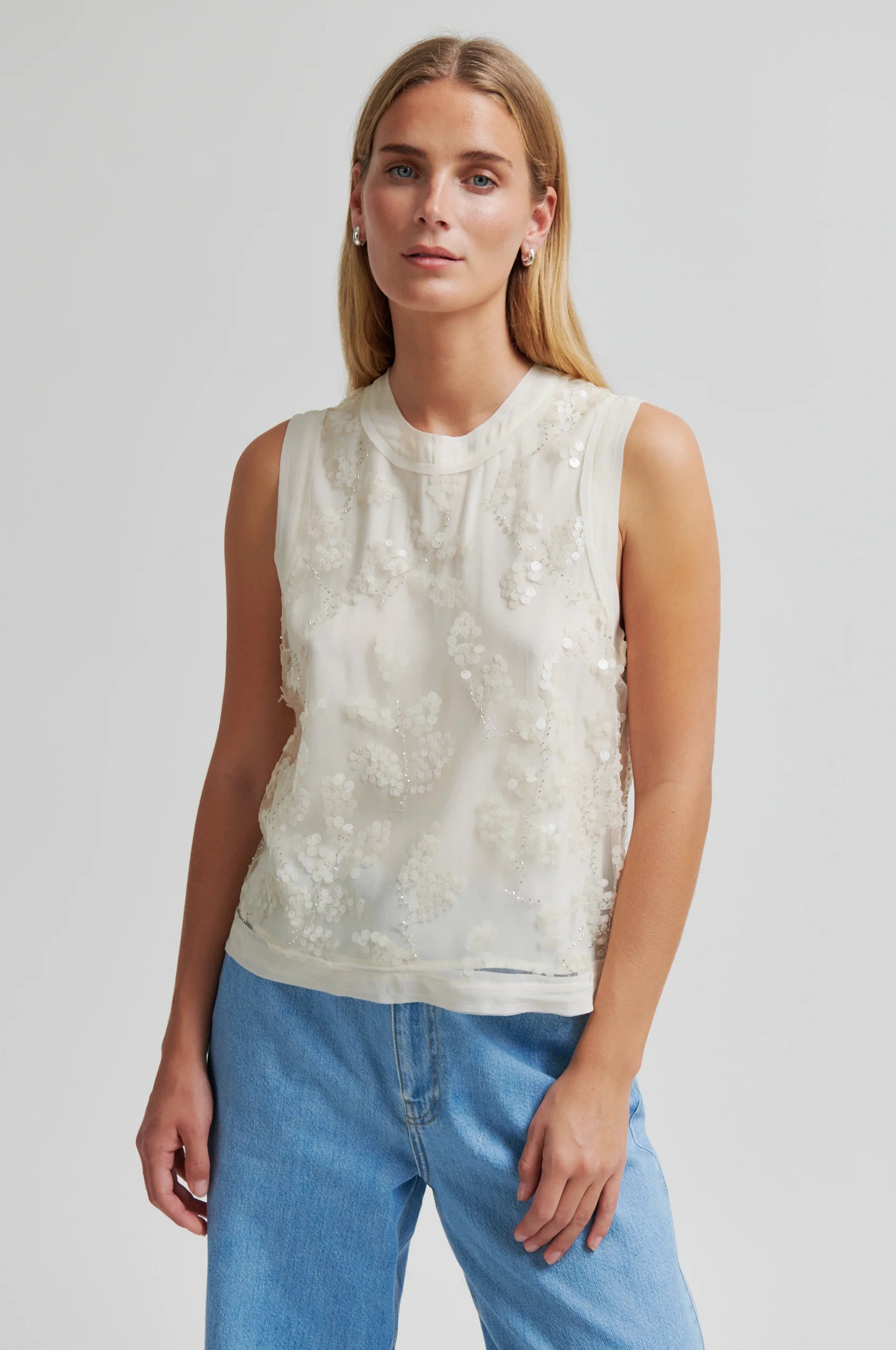 Cream sequin detail top worn with blue jeans