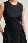 close up of model wearing black dress on white background