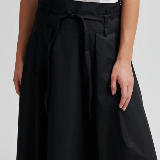 close up of the waist of a black skirt on a model 