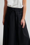 close up of the waist of a black skirt on a model 