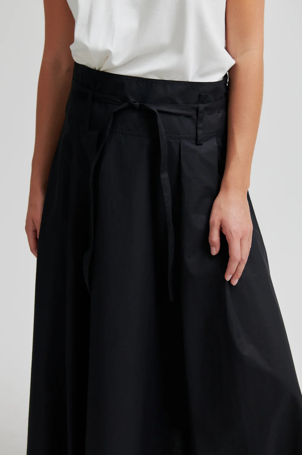 close up of the waist of a black skirt on a model 