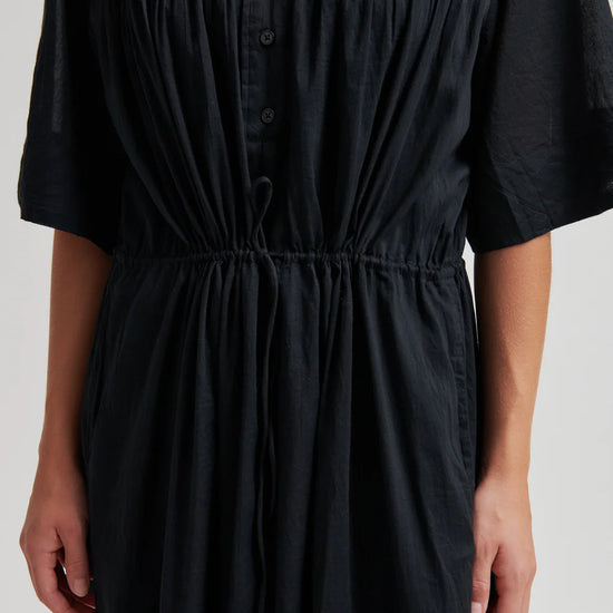 close up of the tie waist detail on the black dress