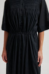 close up of the tie waist detail on the black dress