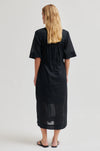 model wearing black dress from the rear 