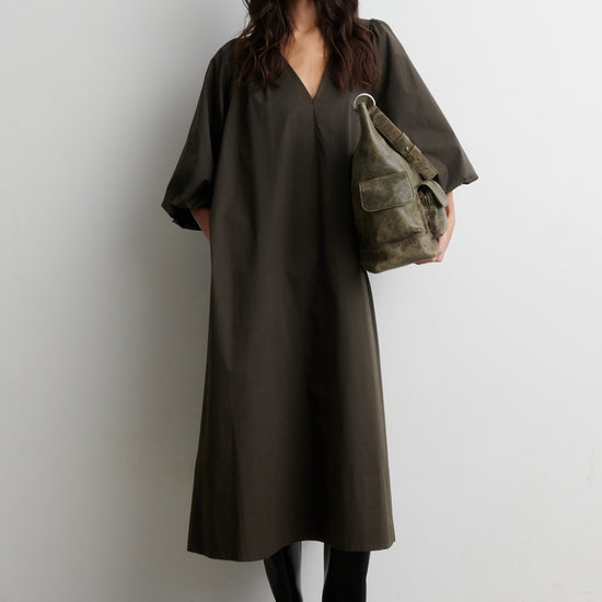 Model wearing dark khaki V neck dress from Second Female