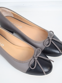 Taupe ballet pump with black toe and bow detail