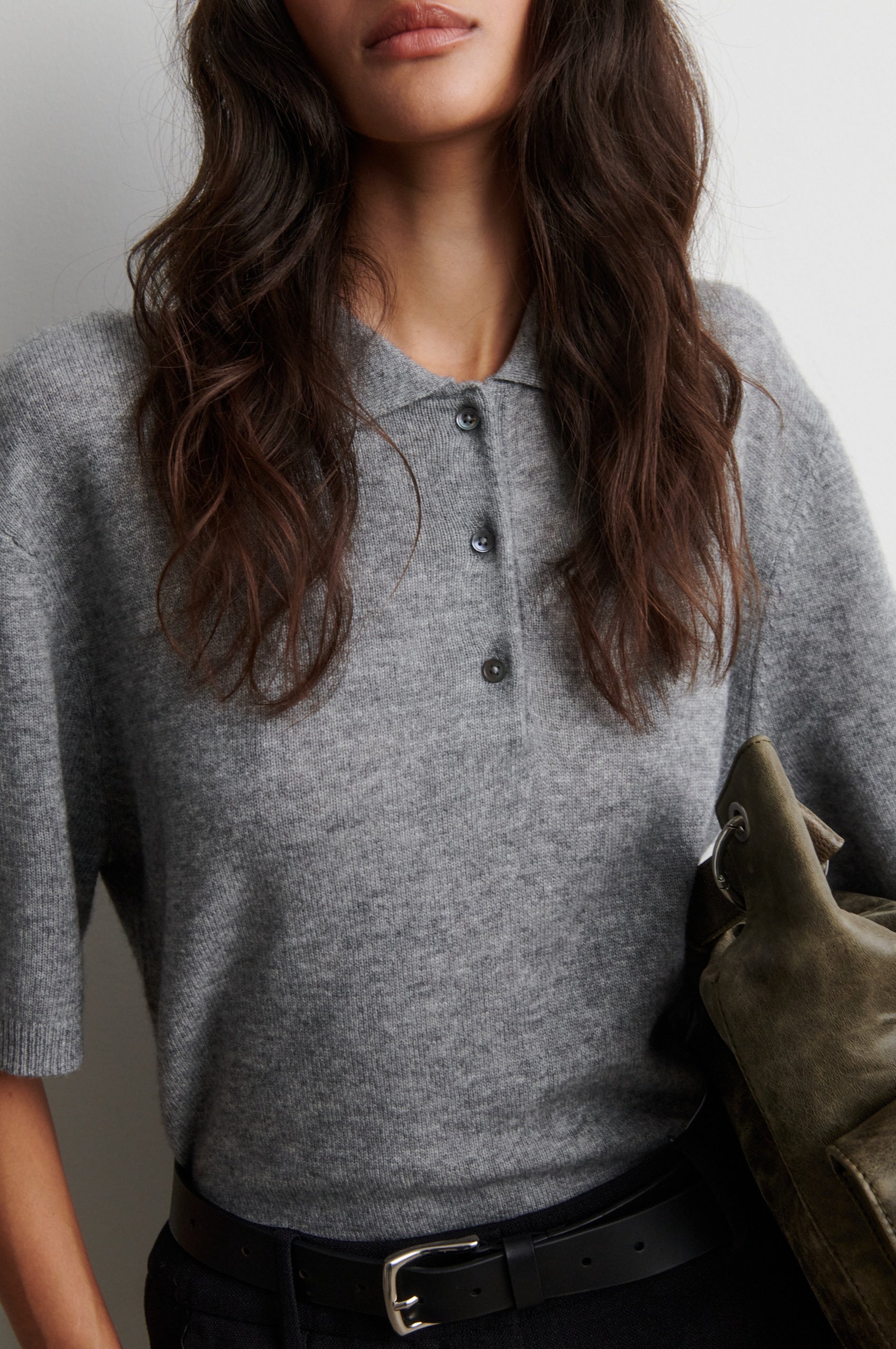 Person wearing a gray cashmere blend short sleeve sweater with a plain background from Second female
