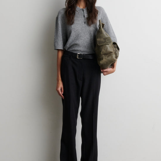 Woman holding a green bag against a plain background wearing a short sleeve cashmere blend jumper from second female