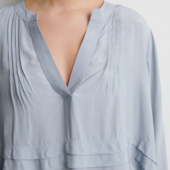 Light blue blouse with a deep neckline on a plain background from Second Female