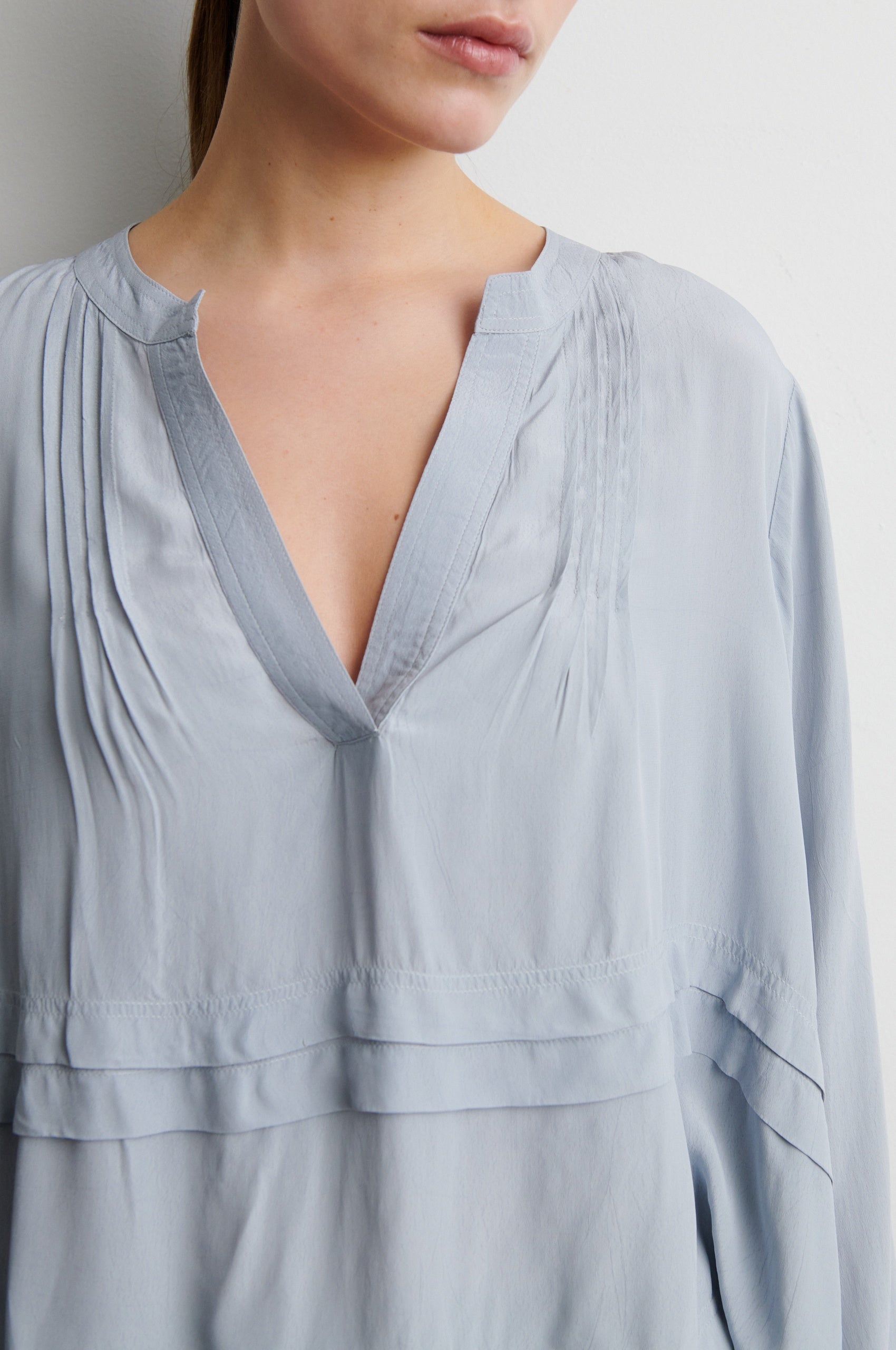 Light blue blouse with a deep neckline on a plain background from Second Female