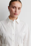 Woman wearing a white shirt against a plain background from Second Female
