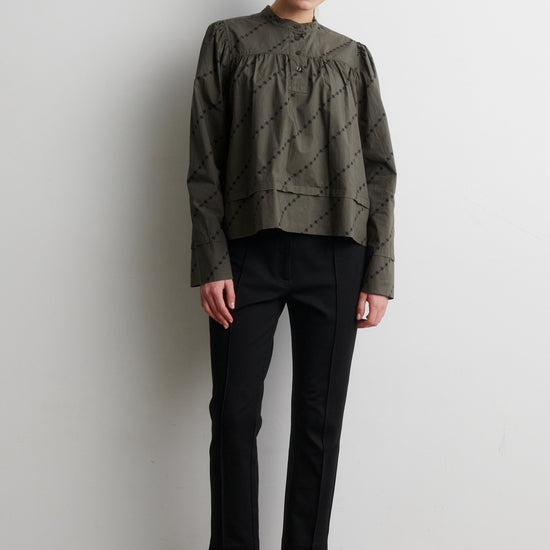 Black trousers from Second Female worn with green shirt
