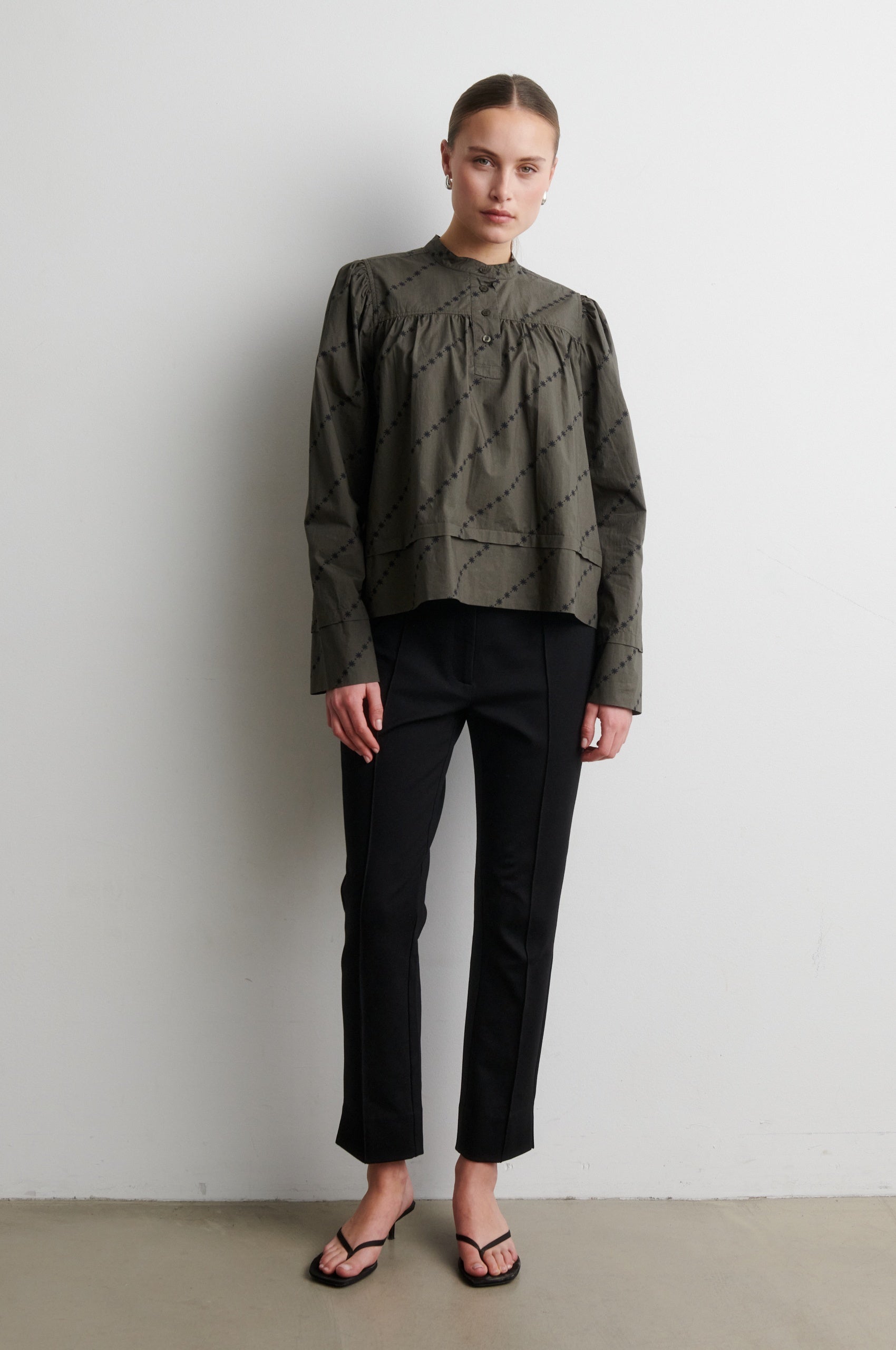 Black trousers from Second Female worn with green shirt