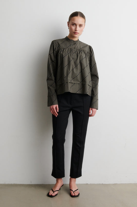 Black trousers from Second Female worn with green shirt