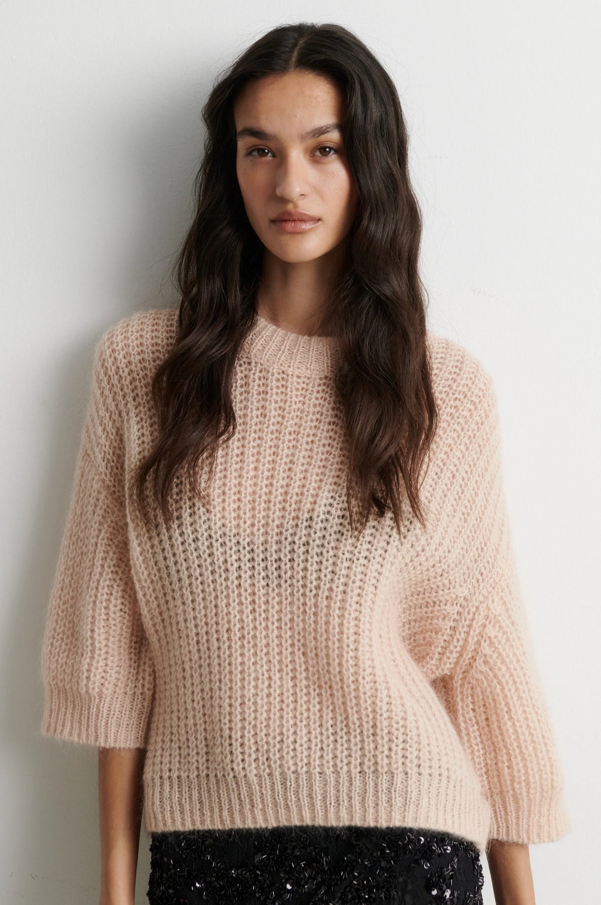Open weave pale pink short sleeve jumper worn with sequin skirt