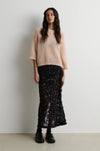Short sleeve open weave pink knit worn with black sequin skirt