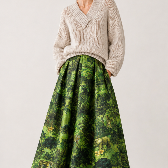 model shot of a green statement skirt and a beige piece of knitwear 
