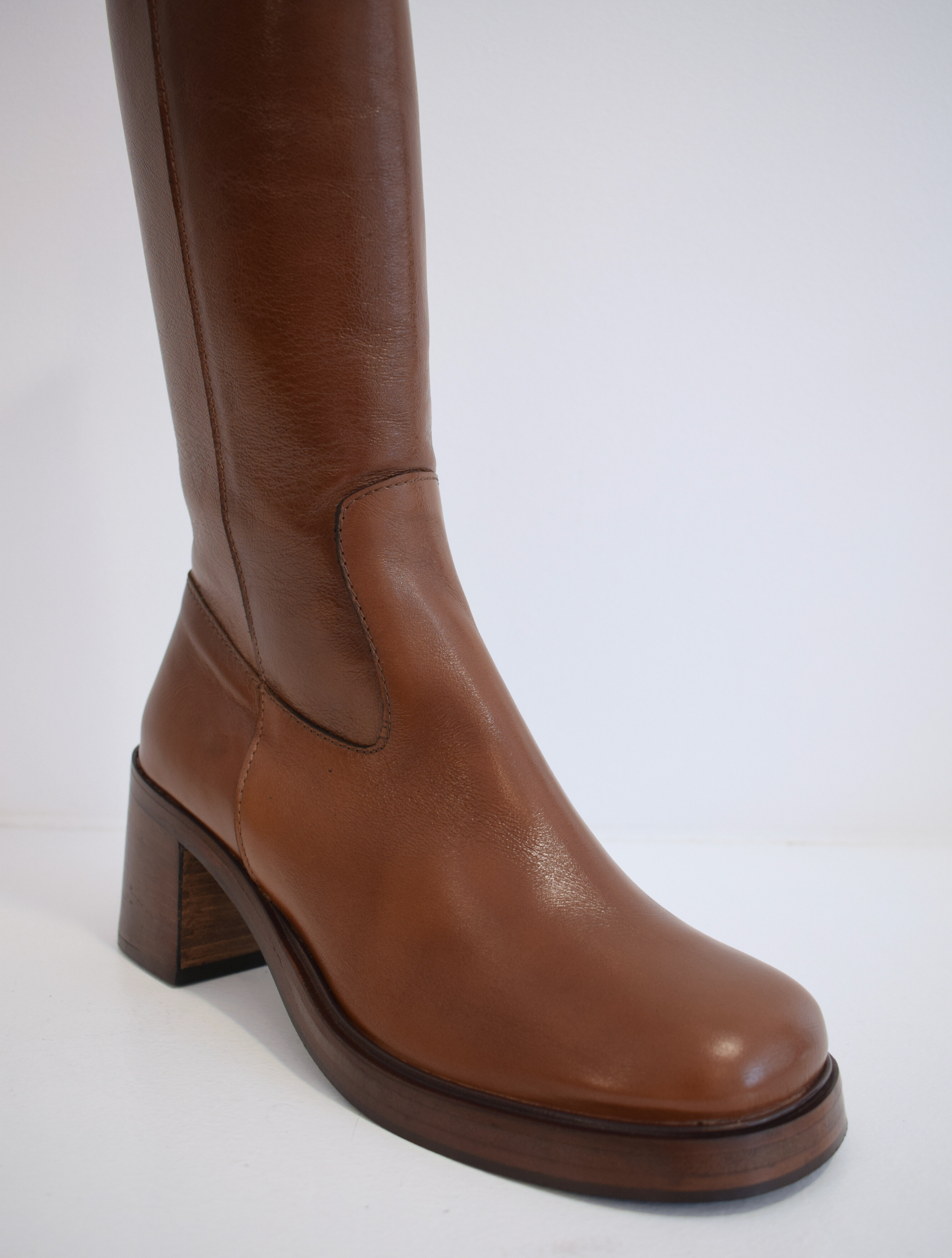 Chestnut brown medium length boot with round toe woodne block heel and wooden platform sole with inner zip fastening