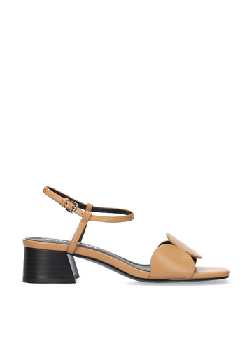 Tan sandal with a black heel on a white background