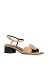 Tan sandal with black heel and strap on a white background