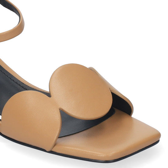 Tan sandal with heart-shaped straps on a white background