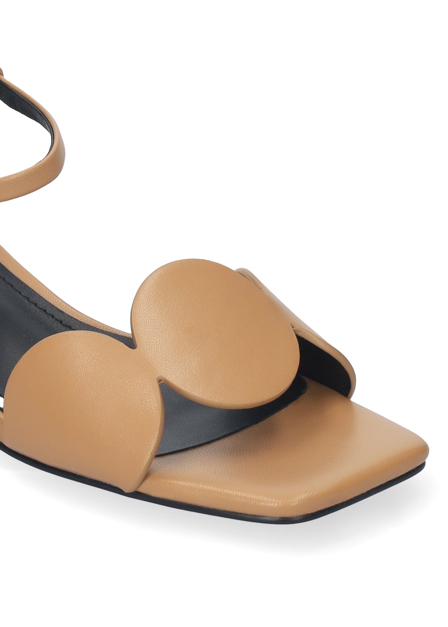Tan sandal with heart-shaped straps on a white background