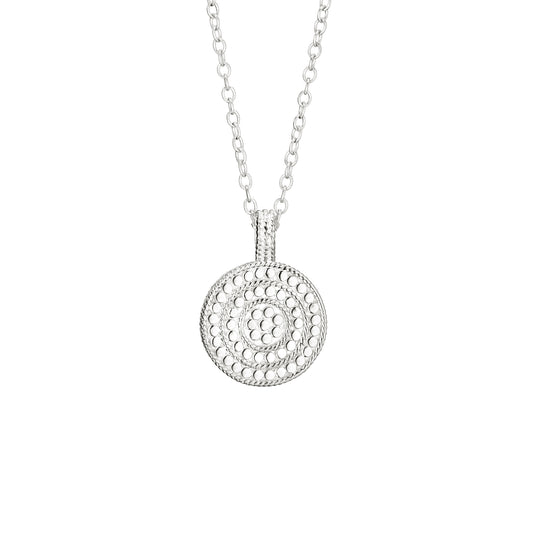 Silver necklace with a circular pendant on a white background