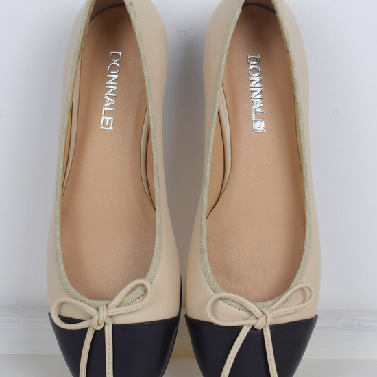 Blush and black ballet pumps with bow and contrast toe