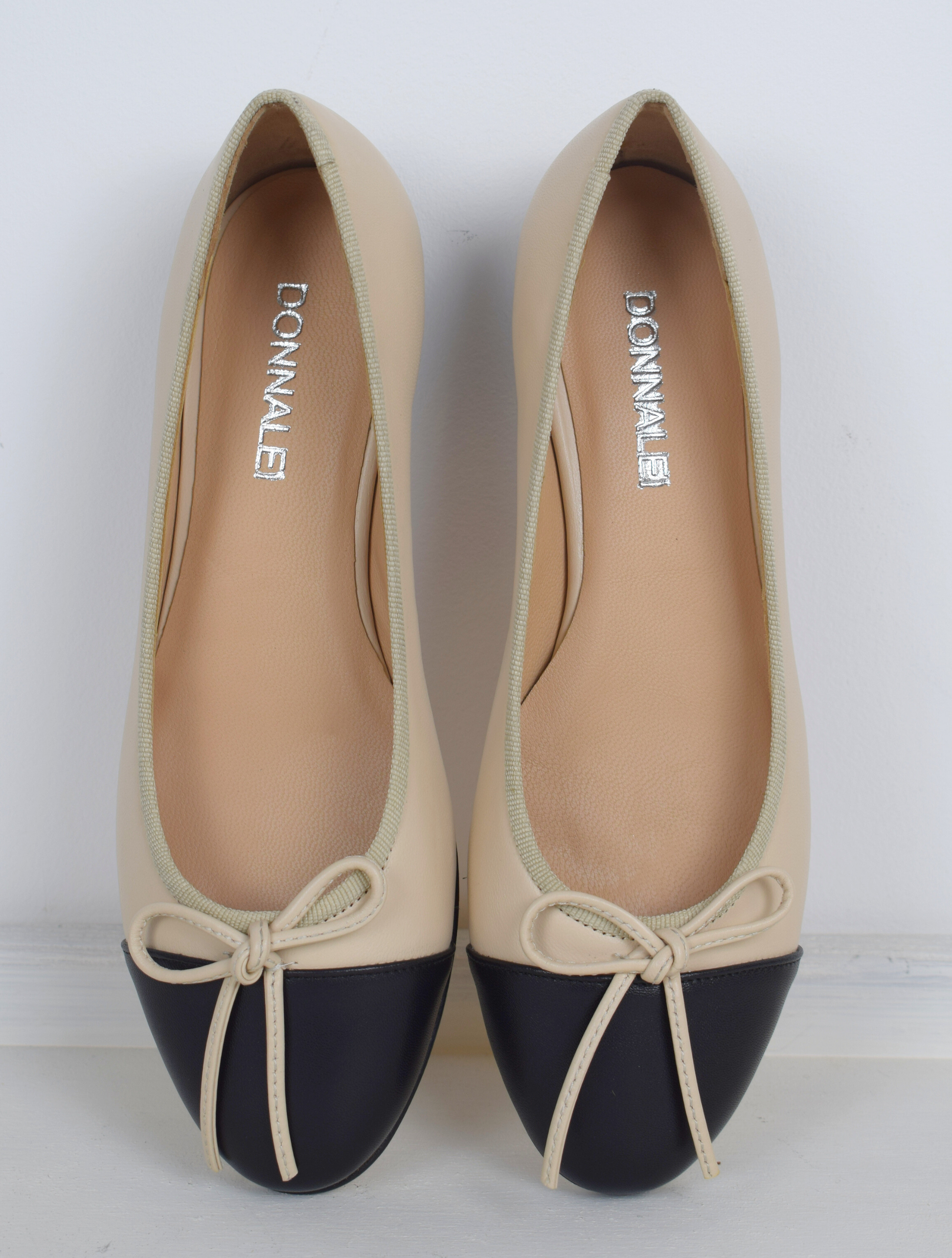 Blush and black ballet pumps with bow and contrast toe