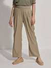 Model wearing stone colour loose fitting trousers, front view