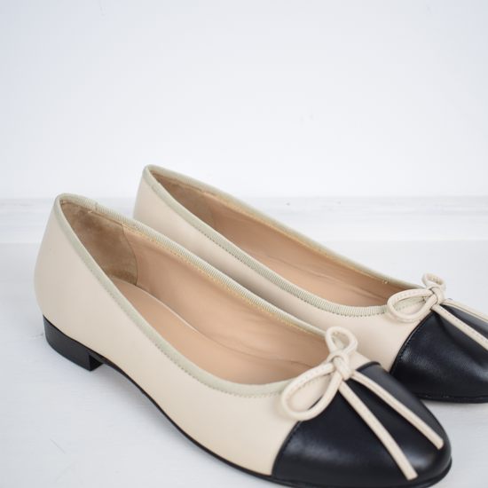 Blush and black ballet pumps with bow and contrast toe