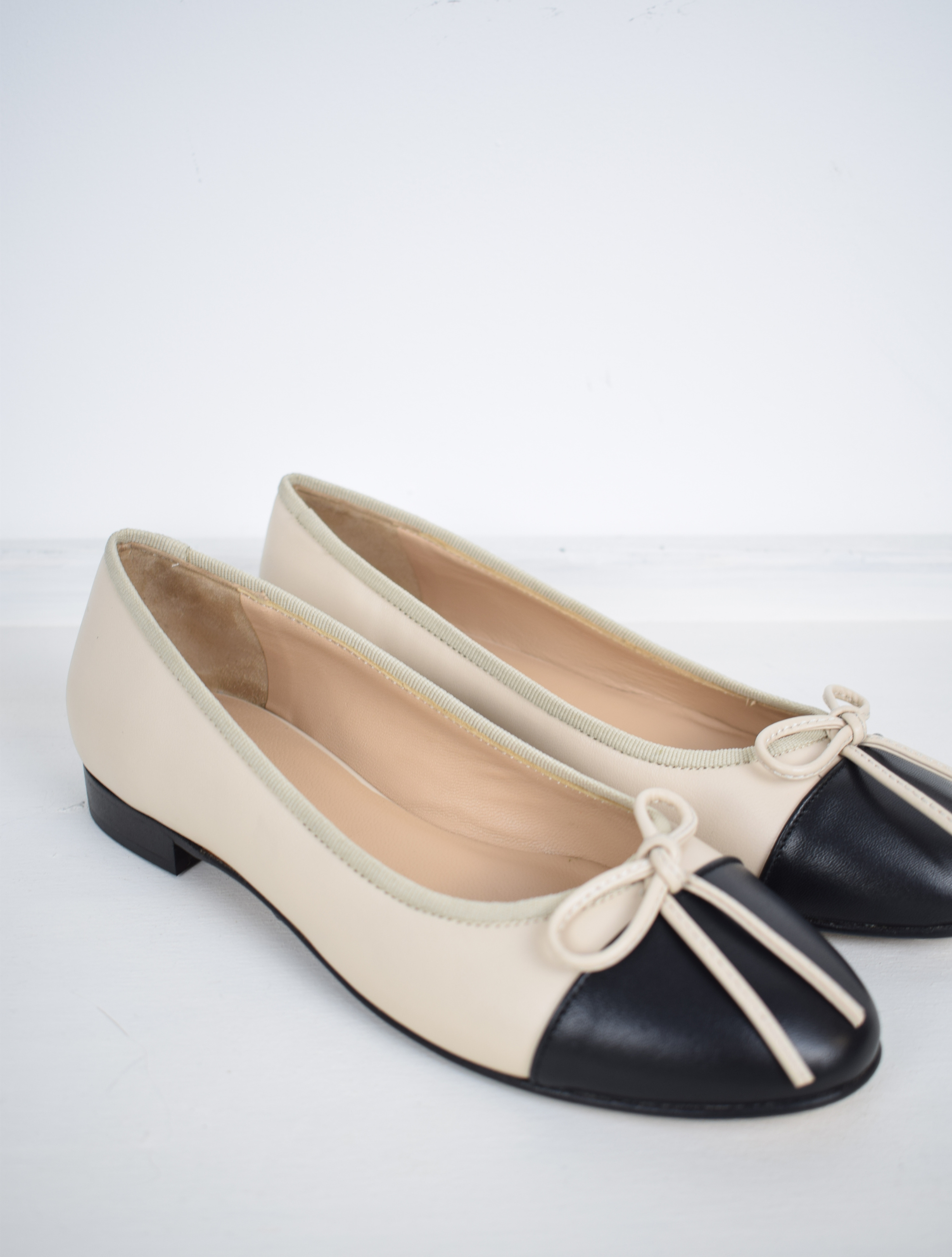 Blush and black ballet pumps with bow and contrast toe