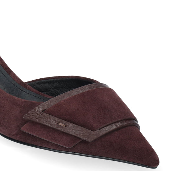 A close-up of a pointed-toe flat shoe in deep burgundy suede with a dark brown leather strap detail across the front, shown on a clean white background.
