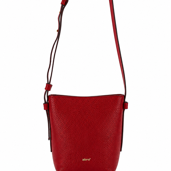 A red pebbled leather crossbody bag with a thin matching red strap and a small gold 'abird' logo on the front, shown against a plain white background.