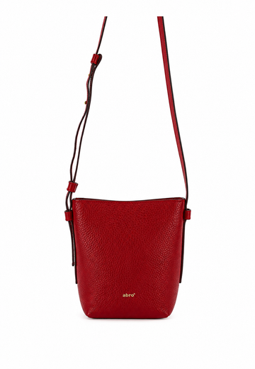 A red pebbled leather crossbody bag with a thin matching red strap and a small gold 'abird' logo on the front, shown against a plain white background.