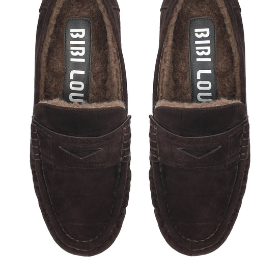 A pair of dark brown suede slip-on loafers with a plush brown faux-fur lining, shown from a top-down view on a white background. The brand name 'BIBI LOU' is visible on the insole.