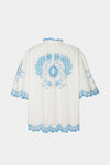 White garment with blue floral embroidery on a white background