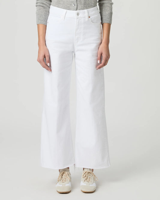 Person wearing white wide-leg paige jeans on a plain background