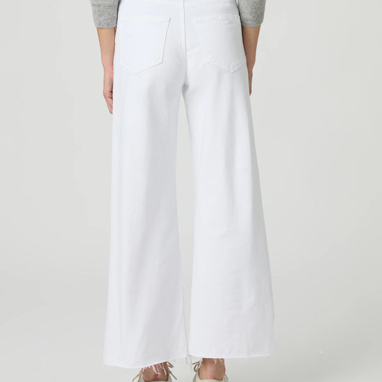 Person wearing white wide-leg paige jeans on a plain background rear view