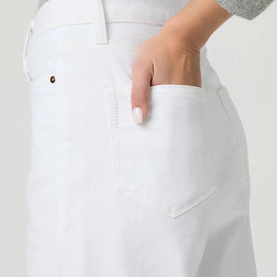 Person wearing white wide-leg paige jeans on a plain background close up